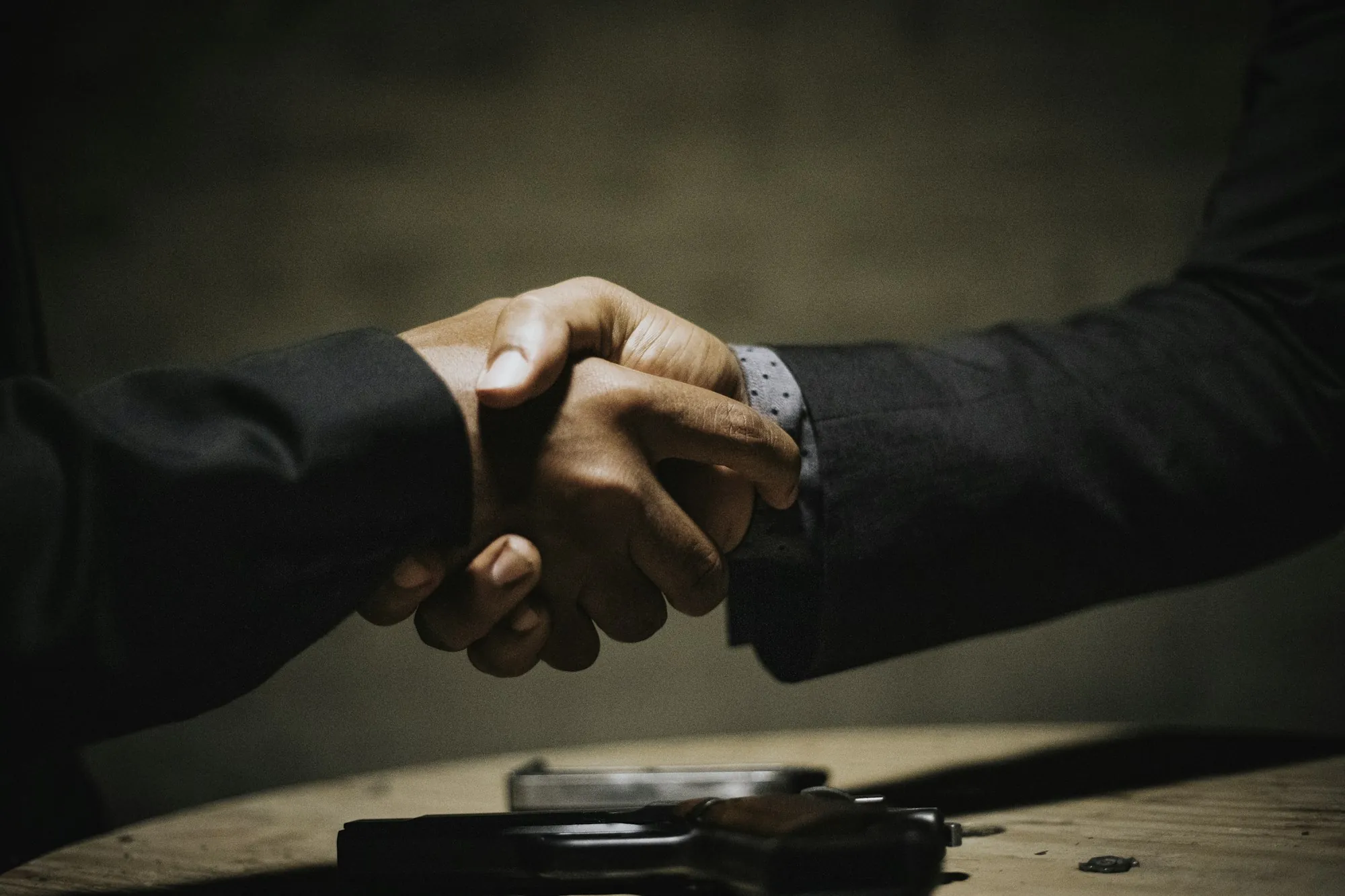 Firm handshake in warm low light